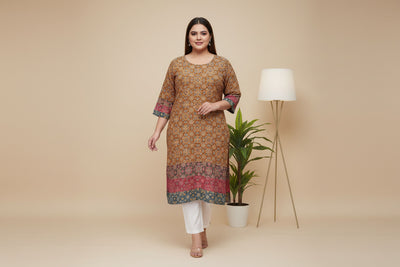 A woman wearing an ajrakh print kurta with white pants